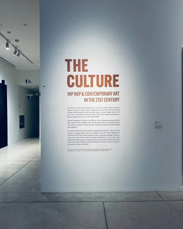 Informational wall display about Hip Hop and Contemporary Art in the 21st Century inside of an art gallery, viewed at eye-level.