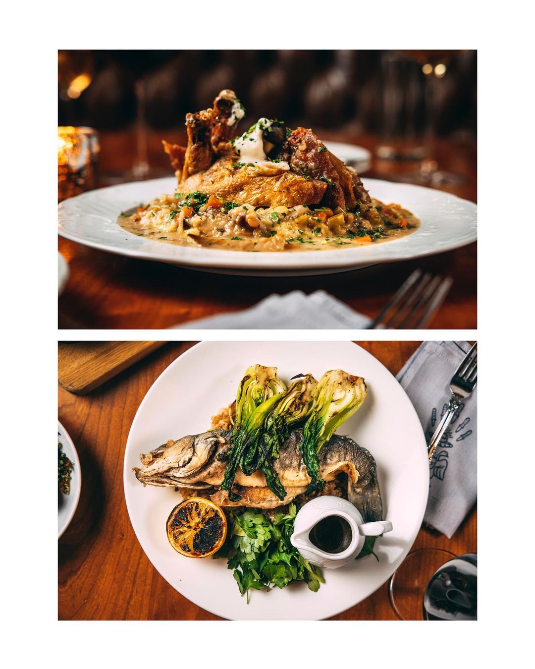Two beautifully plated dishes featuring fried chicken on gravy and baked fish with vegetables on a wooden table, indoor setting.