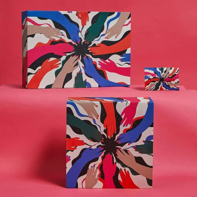 Three boxes with an illustration of hands in various skin tones reaching toward the center, set against a bright pink backdrop.