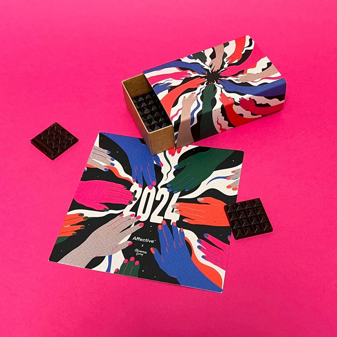 Promotional shot of a chocolate box and an illustrated card on a pink background featuring hand graphics, with 2024 in the center.