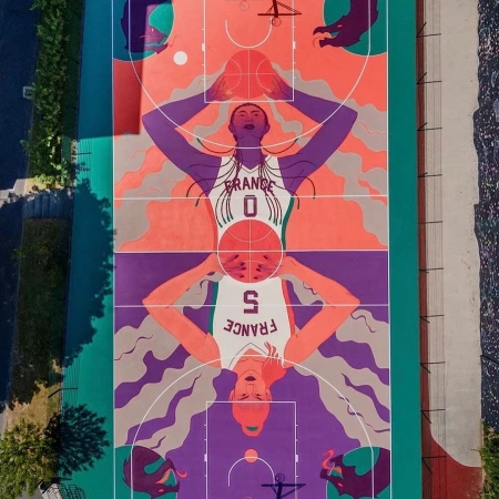Overhead shot of an outdoor basketball court with a mural depicting two women basketball players with a basketball in their hands.