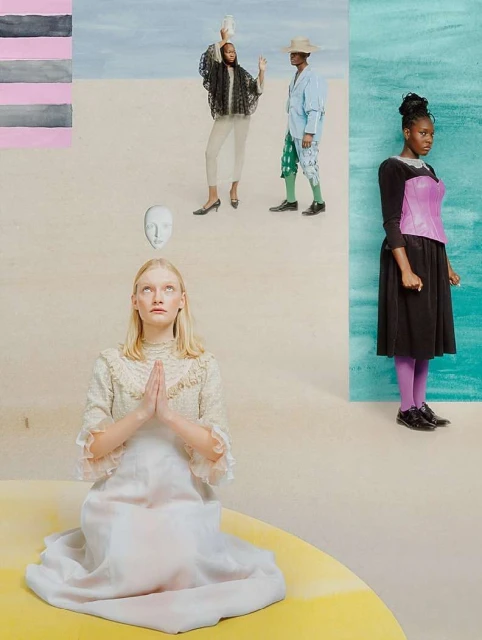 Surreal fashion shot with four women in unique poses and attire against a split background of neutral desert and painted aquamarine.
