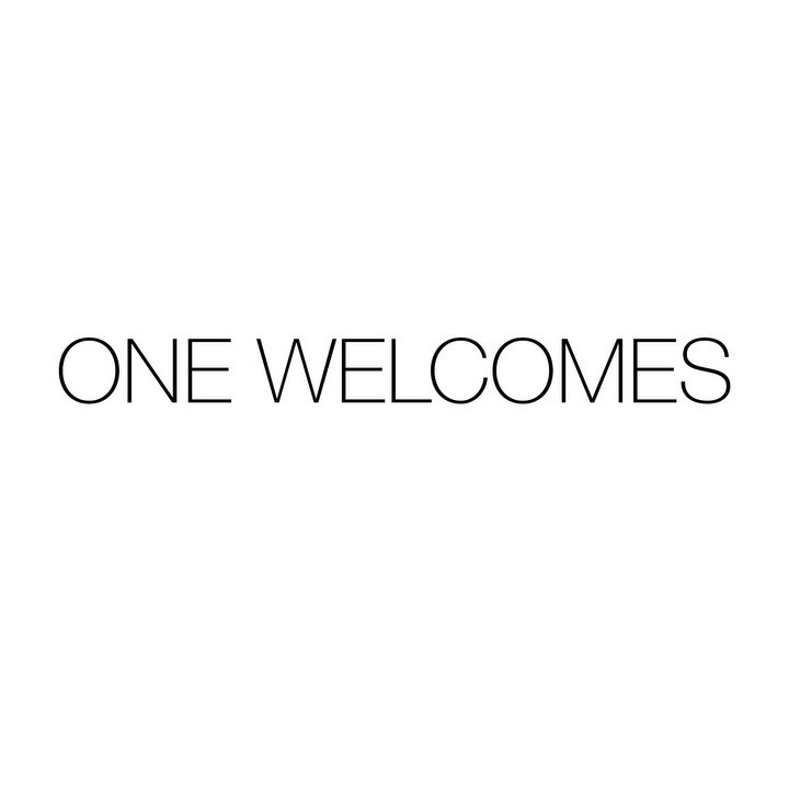 Text graphic art with the phrase 'ONE WELCOMES' in simple black font against a stark white background in a square composition.
