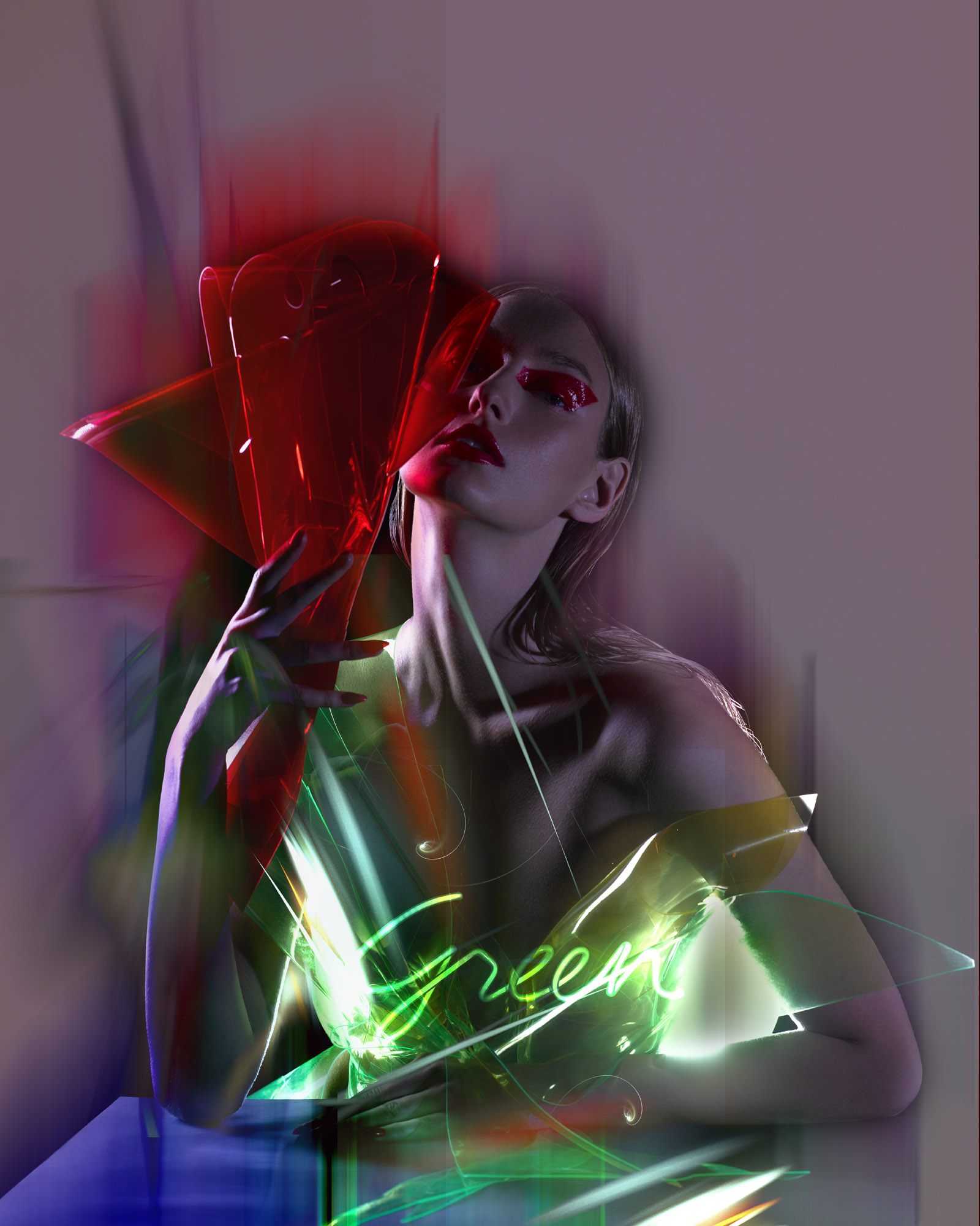 Fashion portrait with a young woman with red makeup and colorful lighting effects. She is posing in an indoor setting with soft lighting.