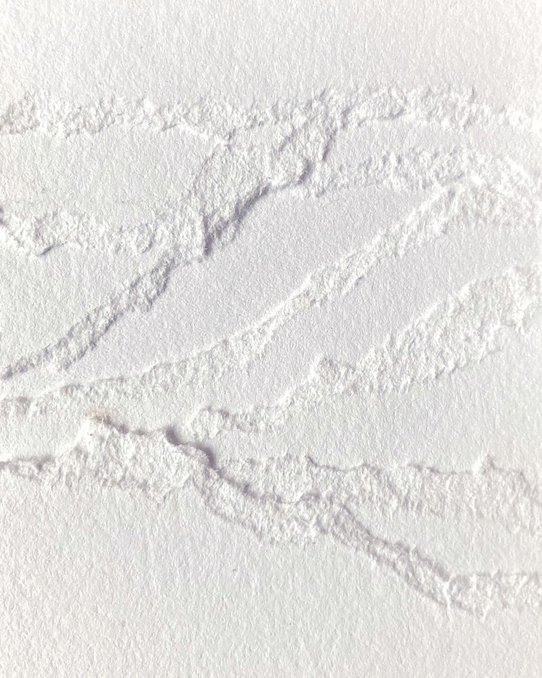 Textured white paper abstract with ragged edges. Minimalist, bright, and clean aesthetic for use as a background or design element.