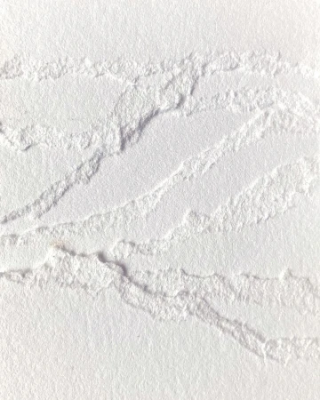 Close-up of textured white paper art with raised tactile embossed lines and torn edges created by Cloe Vriet