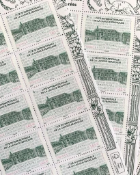 Close-up of a printed sheet of green and white postage stamps featuring architectural illustrations by Clovis Retif.