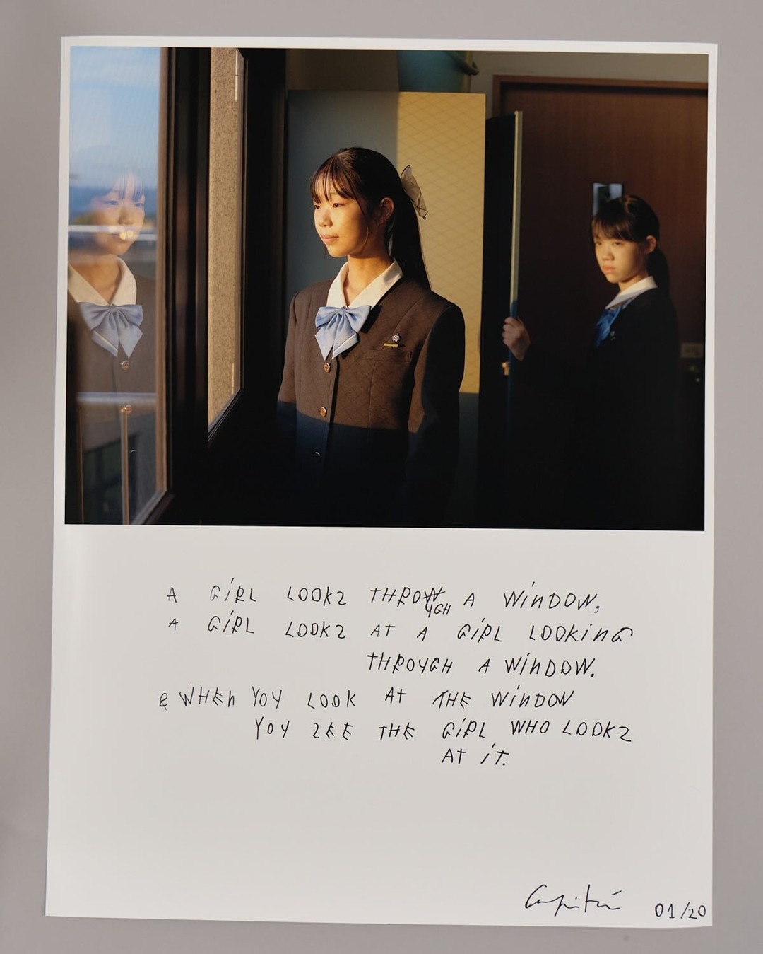 Two young Asian women in school uniforms are depicted in an indoor scene, one looking out a window, with text overlaid on the photograph.