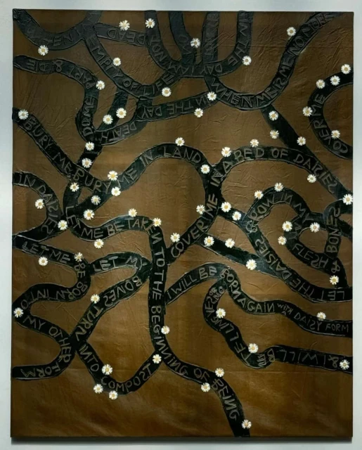 Painting on brown canvas with text on black ribbons and small daisies. The artwork uses symbolic visual language and muted earth tones.