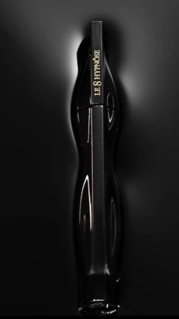 Black mascara bottle, 'Le 8 Hypnôse' branding, beauty shot on dark background, product photography, makeup product, beauty industry.