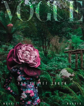 Vogue cover featuring a woman wearing a floral dress and a large rose headpiece, standing in a lush green forest.