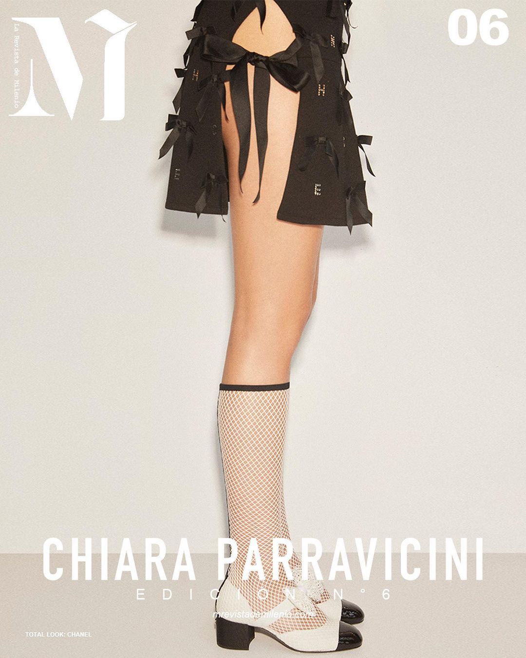 Fashion magazine cover featuring a woman's legs in white fishnet socks, black and white heels, and a black skirt with ribbon details.