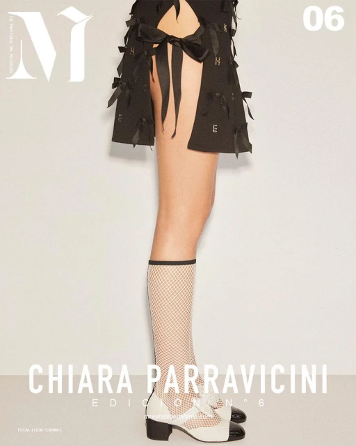 Fashion magazine cover featuring a woman's legs in white fishnet socks, black and white heels, and a black skirt with ribbon details.