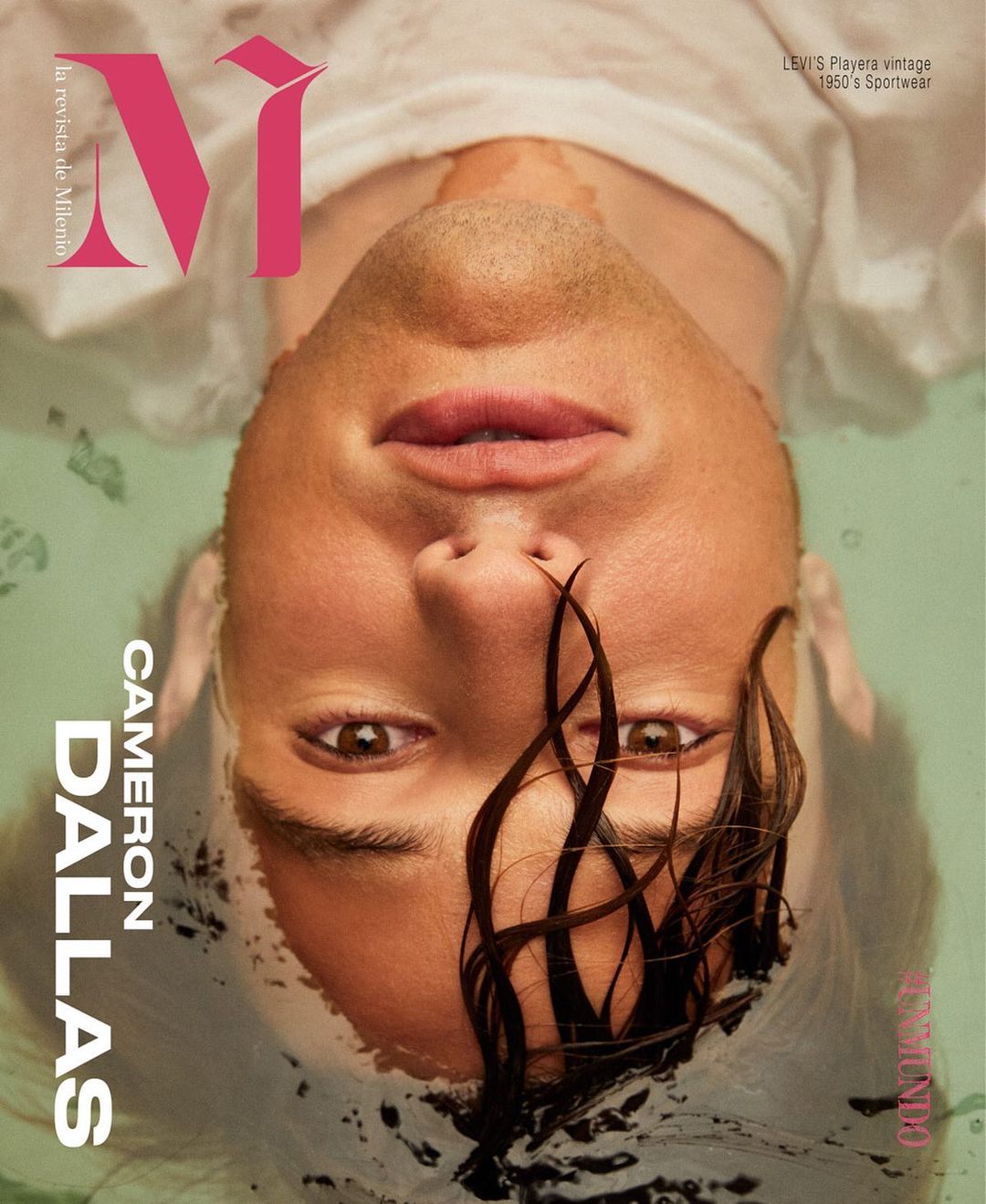 Magazine cover featuring Cameron Dallas with wet hair, submerged in water. The image showcases a close-up portrait with visible text and logo.