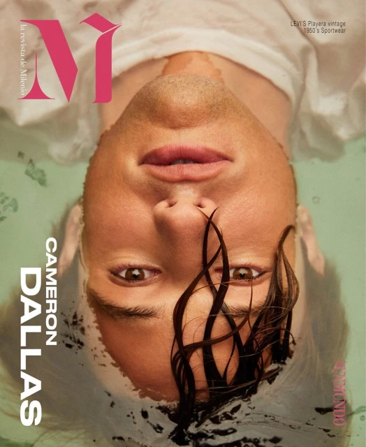 Magazine cover featuring Cameron Dallas with wet hair, submerged in water. The image showcases a close-up portrait with visible text and logo.