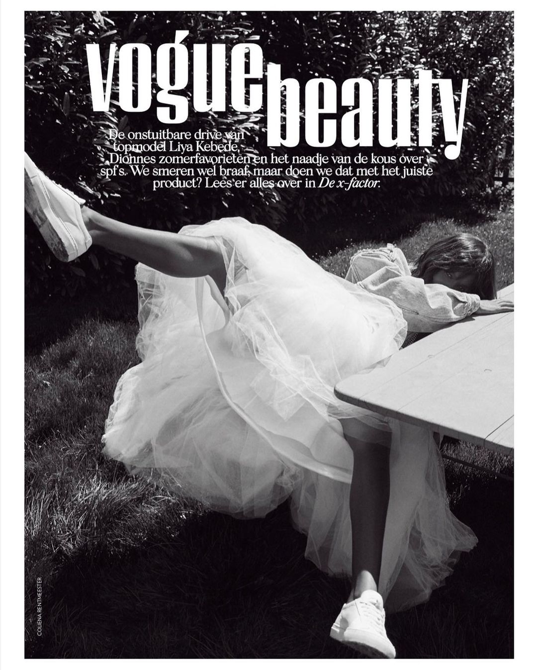 Black and white fashion editorial with an adult female model in a tulle dress and sneakers, lying on a table outside, and magazine cover text.