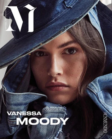 Close-up portrait of Vanessa Moody on a magazine cover, styled in a denim hat and jacket, with a neutral facial expression.