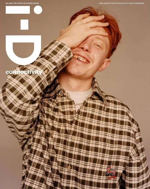 Magazine cover featuring King Krule with red hair, wearing a checkered shirt and touching his forehead with the i-D logo.
