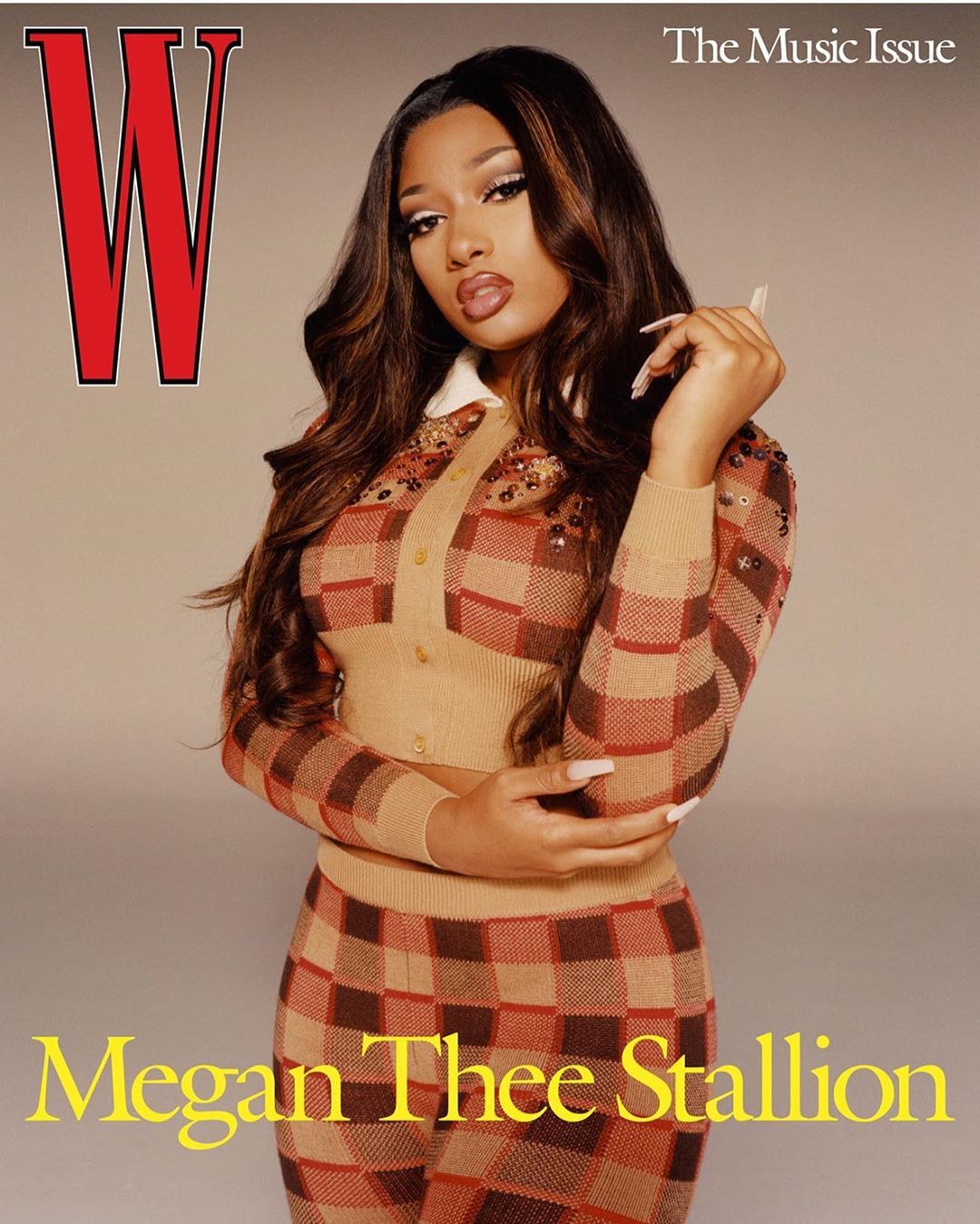 Magazine cover featuring Megan Thee Stallion wearing a brown and tan checkered knit outfit, posing in a studio with neutral background.