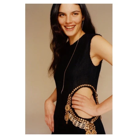 Portrait of smiling woman in black sleeveless dress with embellished cutout by Colin Dodgson