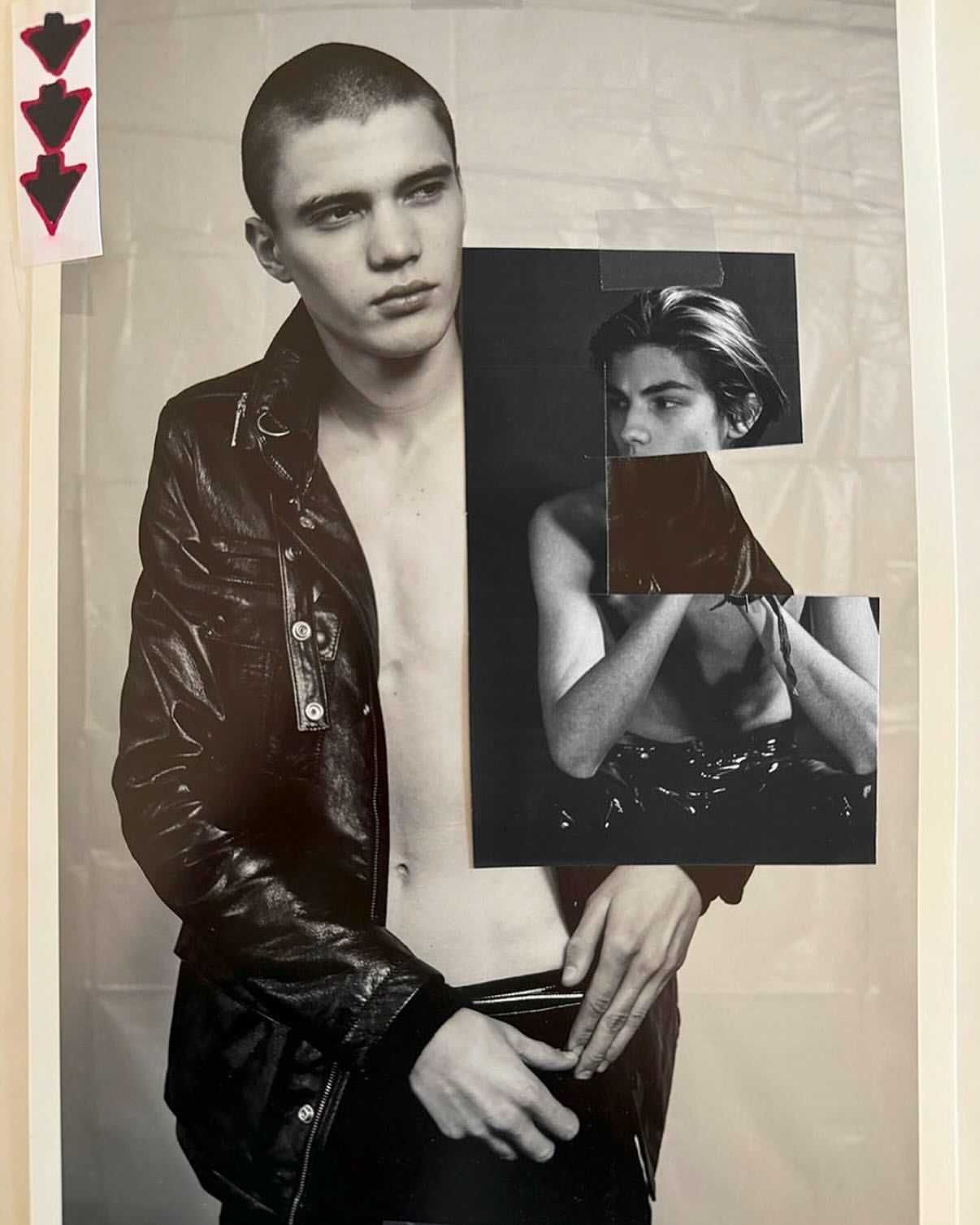 Monochrome collage of a young adult man with a shaved head wearing a leather jacket, against a white plastic-sheet background.