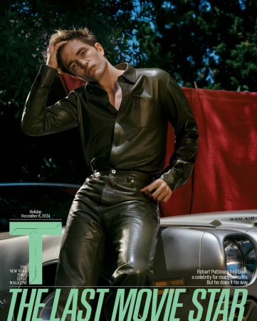 Robert Pattinson in a fashion editorial wearing a leather shirt and pants, leaning against a car. Cover of the New York Times Magazine.