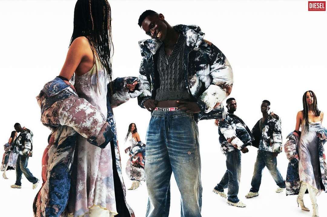 Fashion editorial shot of diverse models wearing Diesel apparel including puffer coats and jeans, standing against a white background.