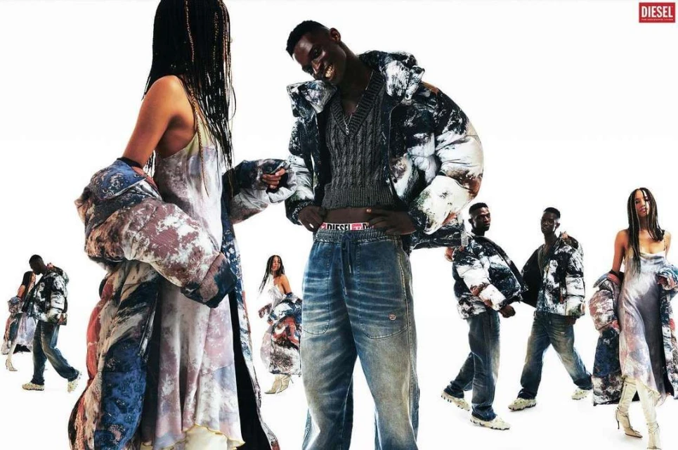 Fashion editorial shot of diverse models wearing Diesel apparel including puffer coats and jeans, standing against a white background.