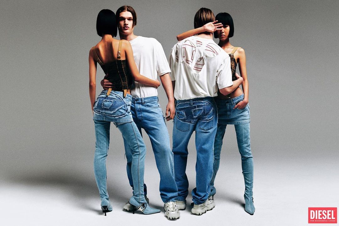 Two women and two men wearing denim and casual tops are posing in a photo studio with a gray background, fashion studio shot.