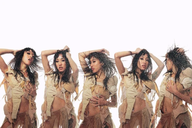 Multiple exposures of an Asian woman in a tan, fringed outfit, under water. The backdrop is bright white, with water droplets visible.