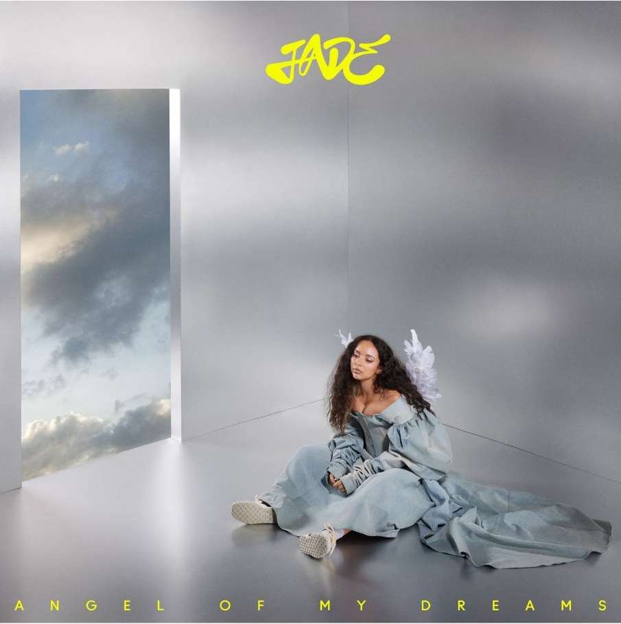 Young woman with angel wings sits gracefully in an ethereal setting, complemented by a window view of cloudy skies, in a light and airy scene.