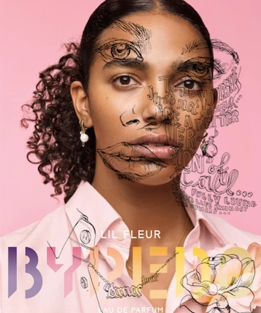 Portrait of a woman with curly hair, wearing a pink shirt and nameplate necklace, illustrated with eyes, lips, and handwritten text on a pink background.