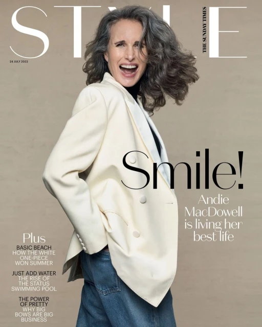 Andie MacDowell smiles on The Sunday Times Style cover, wearing a cream blazer and blue jeans against a neutral background.