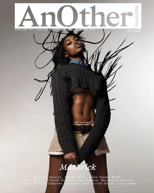 Magazine cover featuring a model in a cropped sweater and khaki skirt. The masthead reads 'Another Magazine'.