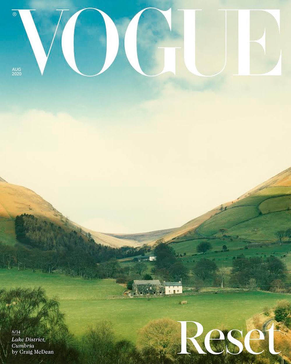 Vogue cover featuring a landscape view of Lake District, Cumbria with rolling hills, fields, and a clear sky.