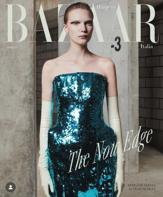 Harper's Bazaar Italia magazine cover featuring a woman in a teal sequined dress and elbow-length gloves, posing in a concrete setting.