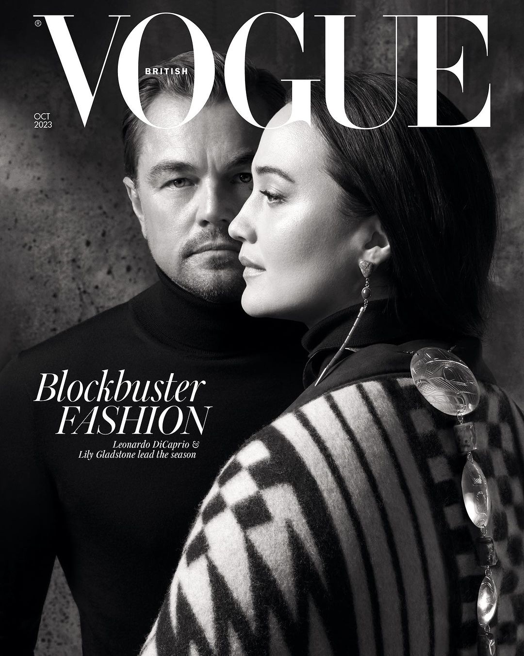Black and white fashion magazine cover featuring Leonardo DiCaprio and Lily Gladstone looking stylish in black turtleneck and patterned shawl.