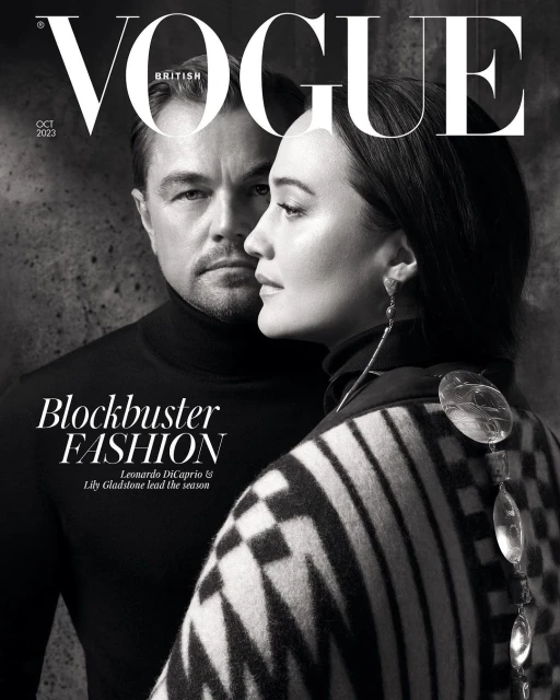 Black and white fashion magazine cover featuring Leonardo DiCaprio and Lily Gladstone looking stylish in black turtleneck and patterned shawl.