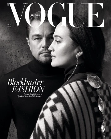 Black and white fashion magazine cover featuring Leonardo DiCaprio and Lily Gladstone looking stylish in black turtleneck and patterned shawl.
