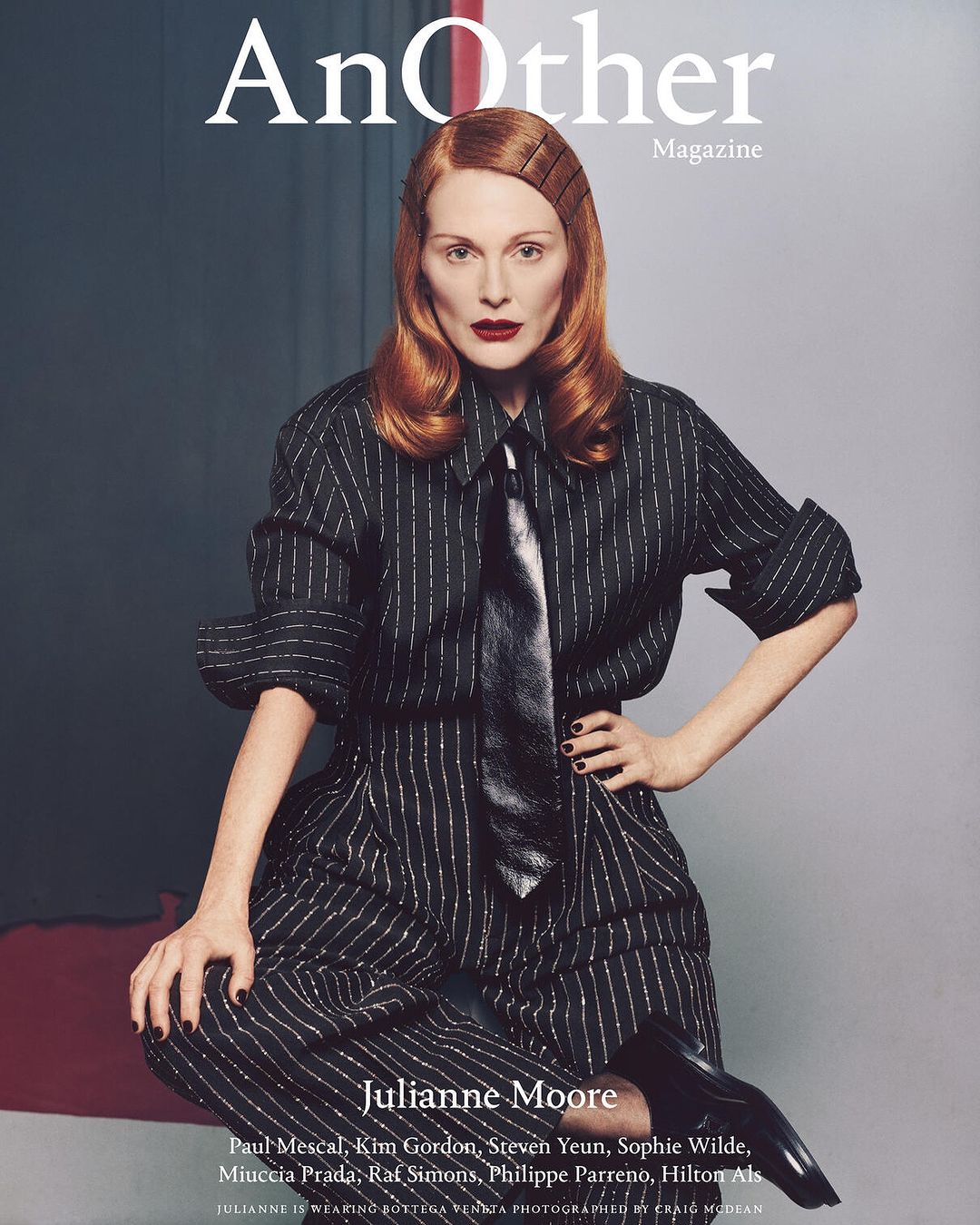 Magazine cover featuring Julianne Moore in a striped suit and tie, with red hair and dark lipstick, against a neutral background.