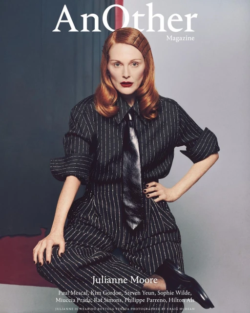 Magazine cover featuring Julianne Moore in a striped suit and tie, with red hair and dark lipstick, against a neutral background.