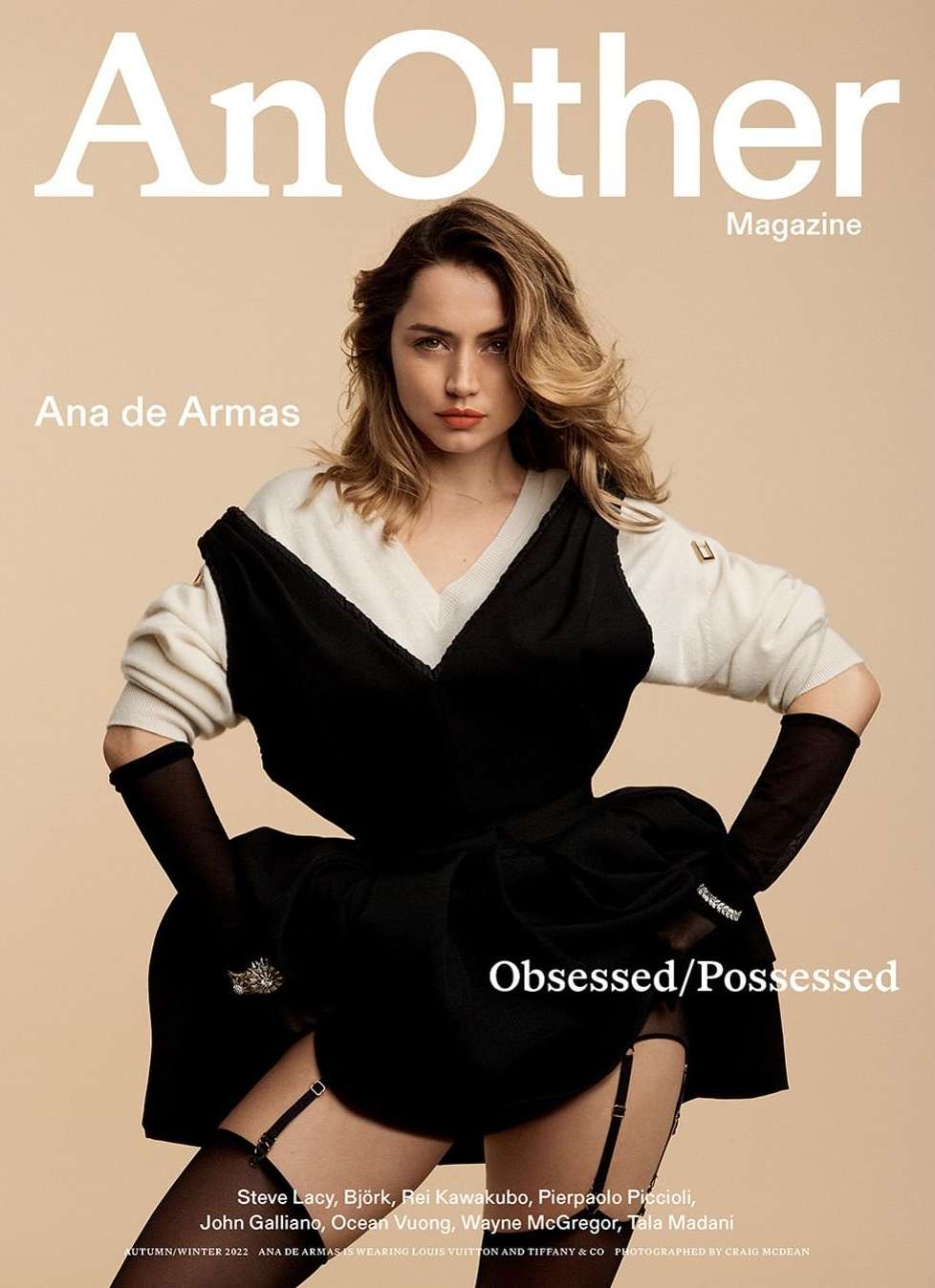 Ana de Armas on magazine cover with text 'AnOther Magazine Obsessed/Possessed'. She's in a fashionable dress, stockings, and gloves.