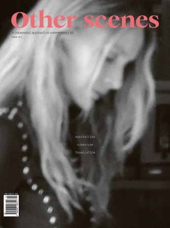 Magazine cover featuring a blurry portrait of a blonde woman in a black and white photo with pink text overlay.