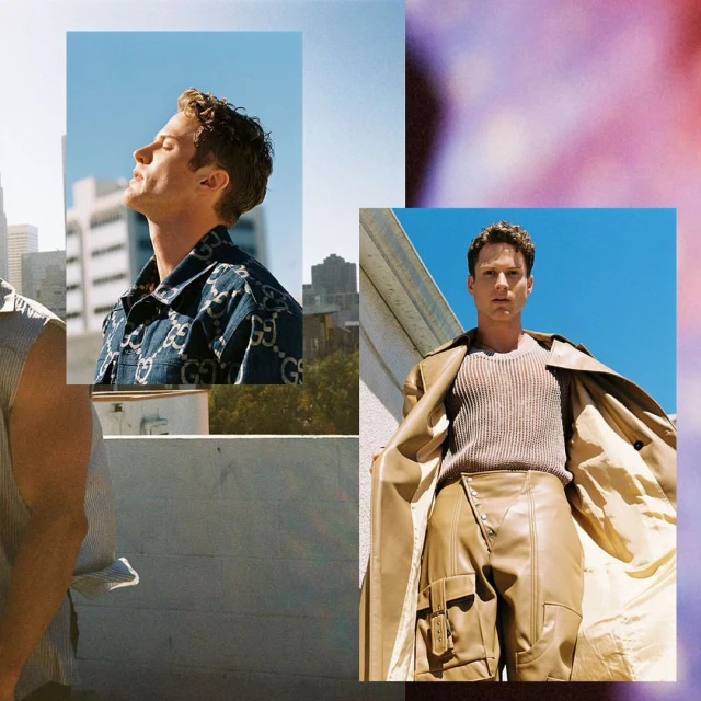 Fashion editorial shot of a young adult male model posing outdoors in a beige trench coat and futuristic beige pants in an urban setting.