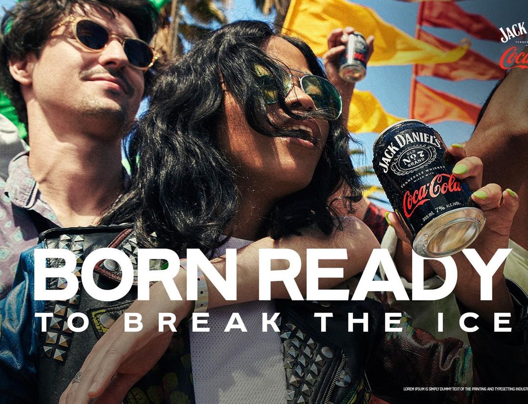 A man and woman pose, holding cans of Jack Daniel's and Coca-Cola. Text overlays the image with the words 'Born Ready to Break the Ice'.