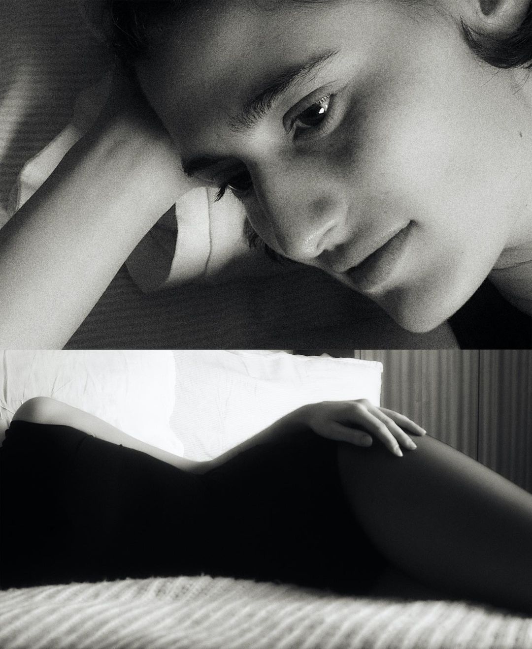 Monochrome portrait of a young woman lying in bed with her head resting on her arm, eyes looking towards the viewer. 
