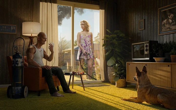 Indoor shot of a senior man connected to oxygen, seated in a chair, with a young woman watering the lawn outside, and a dog lying on the floor.