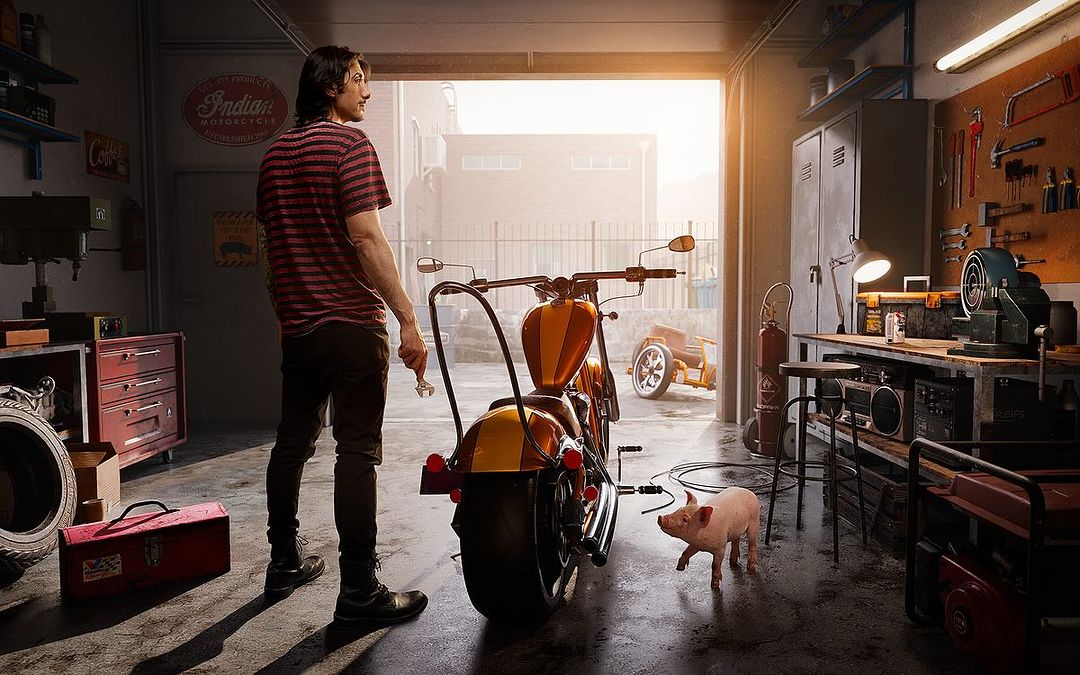 Man in garage with motorcycle and piglet. Motorcycle repair scene with toolbox, tools, and garage workbench in the background.