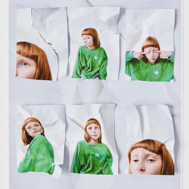 Collage of a child with auburn hair, wearing a green hooded sweatshirt, printed on torn white paper against a white background.