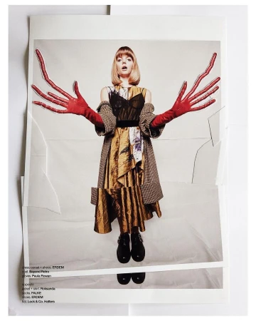 Model with blonde bob wearing oversized red gloves and patterned dress in a paper collage editorial photograph by Damian Weilers.